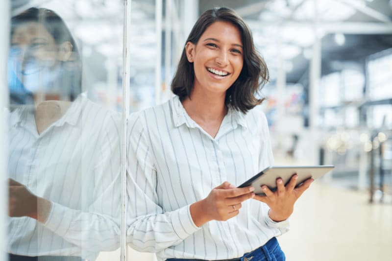 Woman smiling and holding a tablet