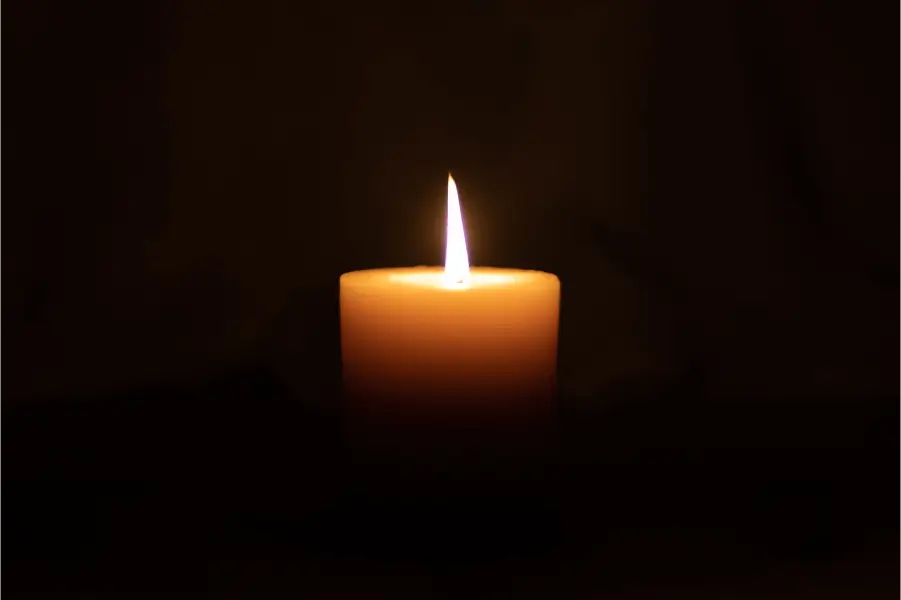 Dark image with light of a candle on the middle