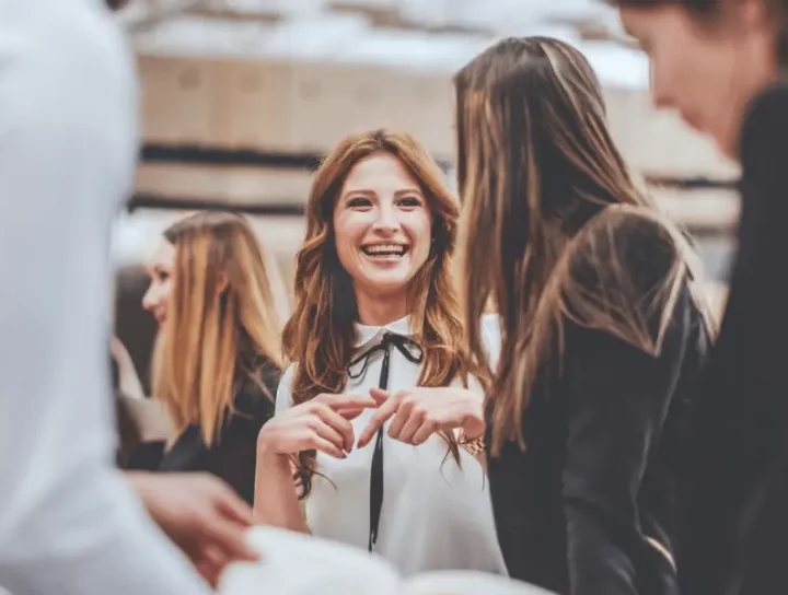 Image of a woman smiling and networking