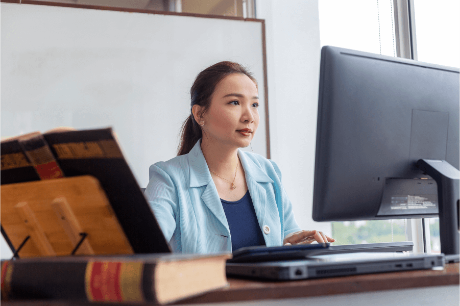 Image of a paralegal working in front of a computer monitor