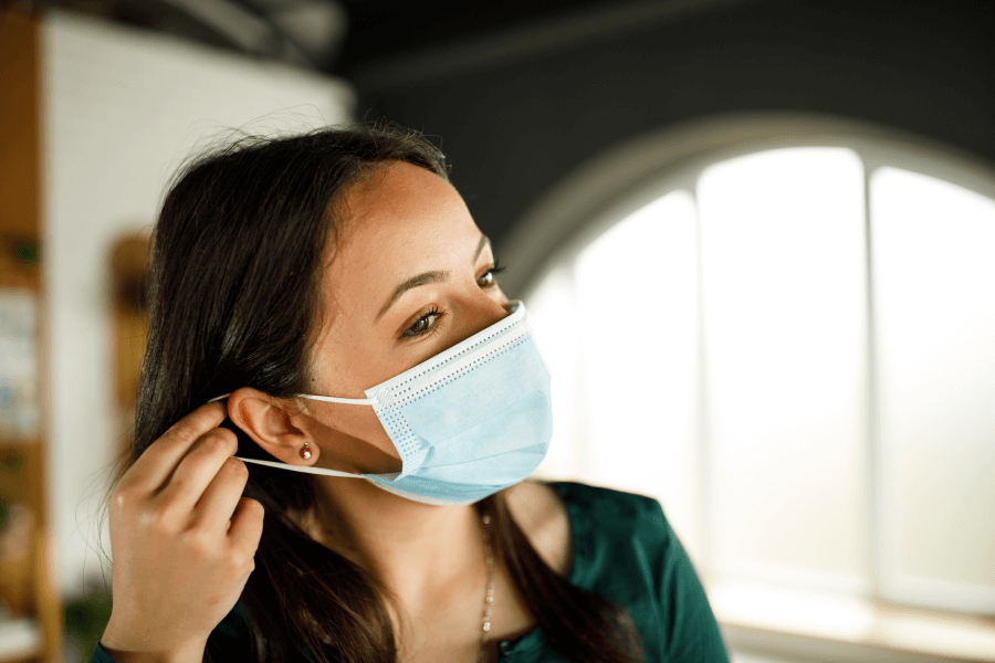 Image of a woman wearing a mask indoors