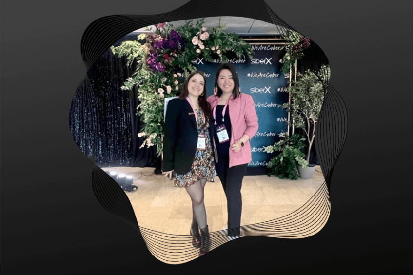 Image of two women in cybersecurity smiling